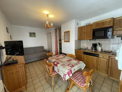 a kitchen and a living room with a table and chairs at Studio spacieux 4 pers : parking, lave-vaisselle, proche télécabine - FR-1-572-108 in Arâches-la-Frasse
