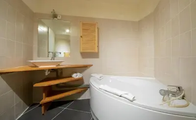a bathroom with a white tub and a sink at L'Outa - Center of Chamonix - Mont-Blanc view in Chamonix-Mont-Blanc