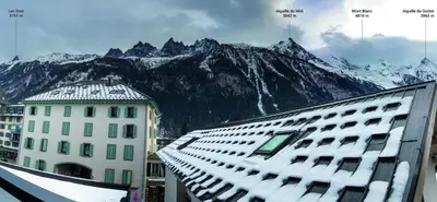 a view of a mountain with snow on the roofs of buildings at L'Outa - Center of Chamonix - Mont-Blanc view in Chamonix-Mont-Blanc