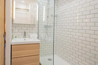 a bathroom with a sink and a glass shower at Forclaz River 1- Beautifully crafted Studio in Chamonix-Mont-Blanc