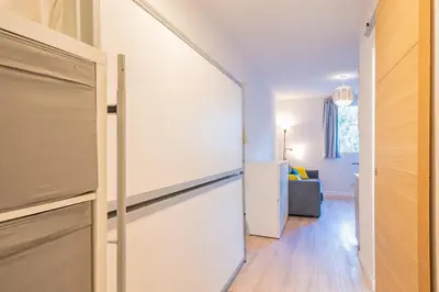 a hallway with a sliding door and a living room at Forclaz River 1- Beautifully crafted Studio in Chamonix-Mont-Blanc