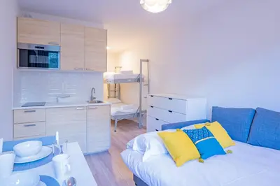 a small room with a bed and a kitchen at Forclaz River 1- Beautifully crafted Studio in Chamonix-Mont-Blanc