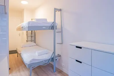 a hospital room with a bunk bed and a desk at Forclaz River 1- Beautifully crafted Studio in Chamonix-Mont-Blanc