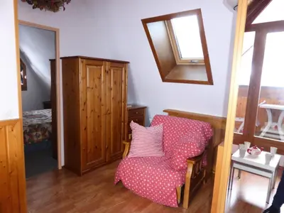 a living room with a chair and a mirror at Résidence L'enclave - Enclave I652 MAE-3414 in Les Contamines-Montjoie