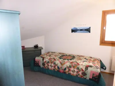 a bedroom with a bed with a quilt on it at Résidence L'enclave - Enclave I652 MAE-3414 in Les Contamines-Montjoie