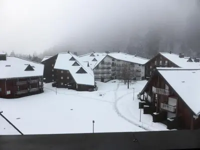 a group of buildings with snow on the roofs at Résidence L'enclave - Enclave I652 MAE-3414 in Les Contamines-Montjoie
