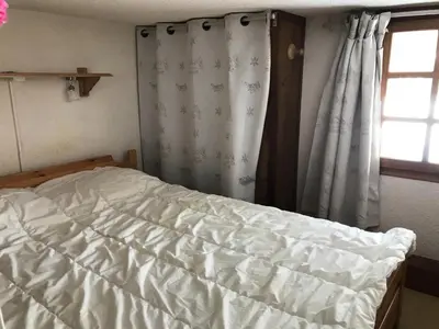 an unmade bed in a bedroom with a window at Résidence Edelweiss - Edelweiss B3 MAE-0844 in Megève