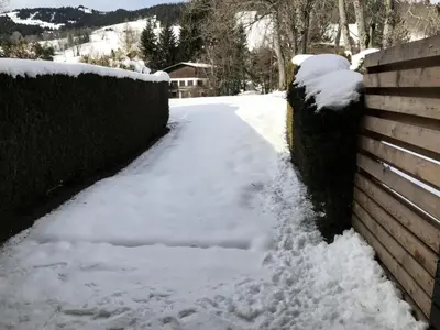 a driveway covered in snow next to a fence at Résidence Edelweiss - Edelweiss B3 MAE-0844 in Megève