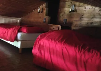 a bedroom with a bed with a red blanket at Résidence Mazot De La Princesse - Chalet de la Princesse MAE-0864 in Megève