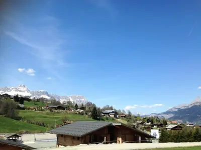 a small building with mountains in the background at Résidence Mazot De La Princesse - Chalet de la Princesse MAE-0864 in Megève