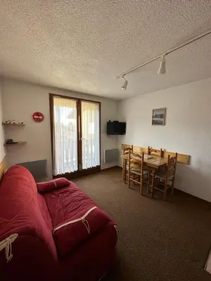 a room with a table and a bed and a dining room at Appartement Les Carroz d'Araches 4 à 6 couchages, vue sur montagne in Les Carroz d'Araches