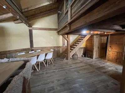 a room with a table and chairs and a staircase at Appartement Cosy 3 Chambres, Centre-Ville, Proche Pistes, Parking, Wifi - FR-1-572-273 in Arâches-la-Frasse
