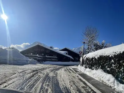 a snow covered road in front of a house at Appartement Cosy 3 Chambres, Centre-Ville, Proche Pistes, Parking, Wifi - FR-1-572-273 in Arâches-la-Frasse