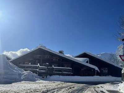 a log cabin with snow on the roof at Appartement Cosy 3 Chambres, Centre-Ville, Proche Pistes, Parking, Wifi - FR-1-572-273 in Arâches-la-Frasse