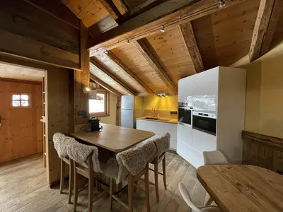 a kitchen with a wooden table and chairs in a room at Appartement Cosy 3 Chambres, Centre-Ville, Proche Pistes, Parking, Wifi - FR-1-572-273 in Arâches-la-Frasse