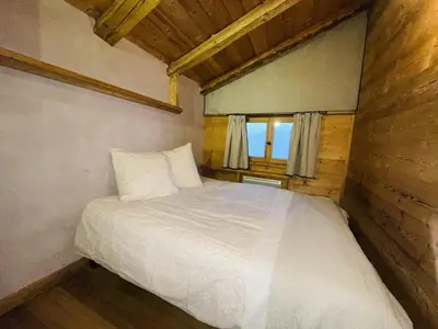 a bedroom with a white bed in a room with a window at Appartement Cosy 3 Chambres, Centre-Ville, Proche Pistes, Parking, Wifi - FR-1-572-273 in Arâches-la-Frasse