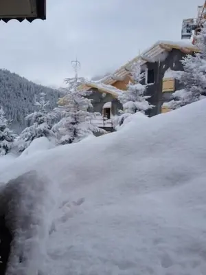 a pile of snow in front of a house at 2 bedroom Apartment in Les Houches Stone's throw from Prairon lift in Les Houches