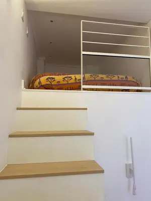 a bedroom with stairs leading to a bunk bed at Chamonix - Majestic vue Mont Blanc in Chamonix-Mont-Blanc