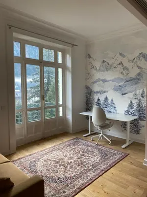 a white room with a desk and a window at Chamonix - Majestic vue Mont Blanc in Chamonix-Mont-Blanc