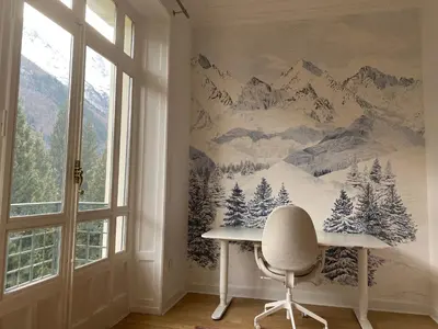 a desk in a room with a mountain mural on the wall at Chamonix - Majestic vue Mont Blanc in Chamonix-Mont-Blanc