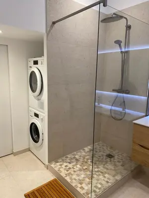 a bathroom with a shower and a washer and dryer at Chamonix - Majestic vue Mont Blanc in Chamonix-Mont-Blanc