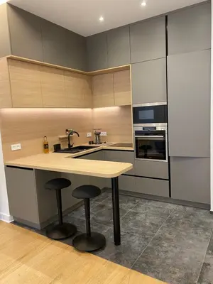 a kitchen with a sink and a counter with stools at Chamonix - Majestic vue Mont Blanc in Chamonix-Mont-Blanc