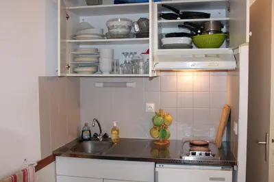 a kitchen with a sink and some plates and dishes at Les Pierres Blanches Contamines Montjoie in Les Contamines-Montjoie