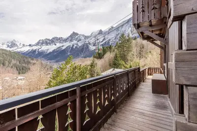 a balcony of a house with a view of mountains at Chalet Kieppi - View off Mont-Blanc range in Les Houches