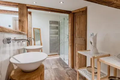 a bathroom with a white bowl sink and a shower at Chalet Kieppi - View off Mont-Blanc range in Les Houches