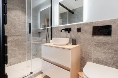 a bathroom with a sink and a shower at Chalet Kieppi - View off Mont-Blanc range in Les Houches
