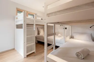 two bunk beds in a small room with two beds at Chalet Kieppi - View off Mont-Blanc range in Les Houches