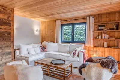 a living room with a couch and two chairs at Appartement Périade - Welkeys in Megève