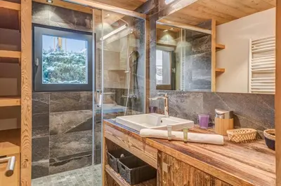a bathroom with a sink and a shower at Appartement Périade - Welkeys in Megève
