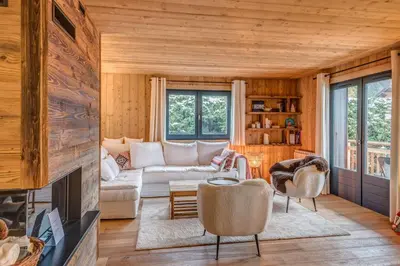 a living room with a couch and a fireplace at Appartement Périade - Welkeys in Megève