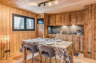 a dining room with a table and chairs at Appartement Périade - Welkeys in Megève