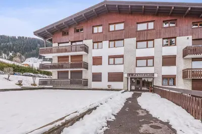a large building with snow in front of it at Appartement Perchets - Welkeys in Megève
