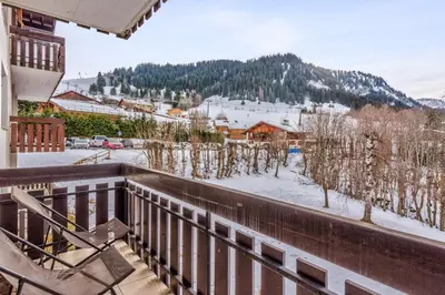 a balcony with a view of a snow covered mountain at Appartement Perchets - Welkeys in Megève