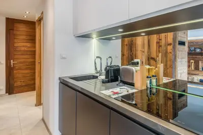 a kitchen with a sink and a counter top at Appartement Perchets - Welkeys in Megève