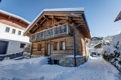a log cabin in the snow with snow around it at Chalet du Jaillet - Welkeys in Megève