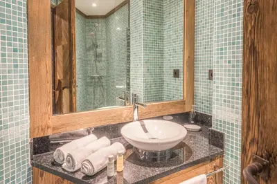 a bathroom with a sink and a mirror at Chalet du Jaillet - Welkeys in Megève