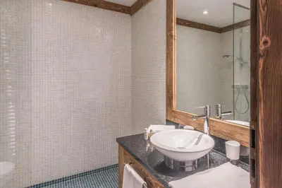 a bathroom with a sink and a mirror at Chalet du Jaillet - Welkeys in Megève