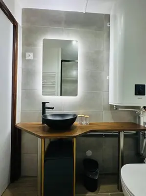 a bathroom with a sink and a mirror at Studio Hyper centre in Les Carroz d'Araches