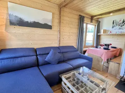 a living room with a blue couch and a table at Appartement 3 pièces + cabine à Megève, 6 couchages, proche pistes et téléphérique - FR-1-597-170 in Megève