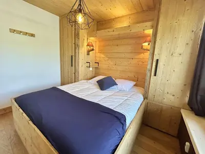 a bedroom with a bed in a wooden room at Appartement 3 pièces + cabine à Megève, 6 couchages, proche pistes et téléphérique - FR-1-597-170 in Megève