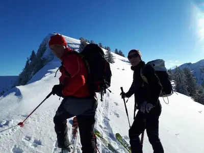 two people walking up a snow covered mountain at Studio agréable in Les Contamines-Montjoie