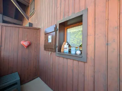 a red wall with a window with a heart at Charmant T2 proche du centre avec parking - FR-1-624-127 in Samoëns
