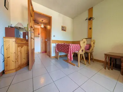 a kitchen with a table and chairs in a room at Charmant T2 proche du centre avec parking - FR-1-624-127 in Samoëns