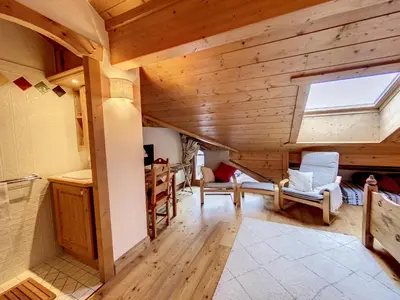 a large room with a wooden ceiling with a window at Bells Lodge in Chamonix-Mont-Blanc