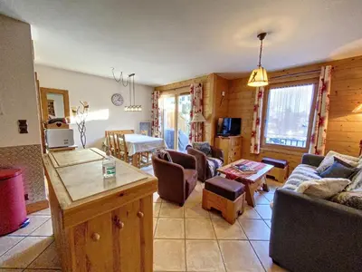 a living room with a couch and a table at Bells Lodge in Chamonix-Mont-Blanc