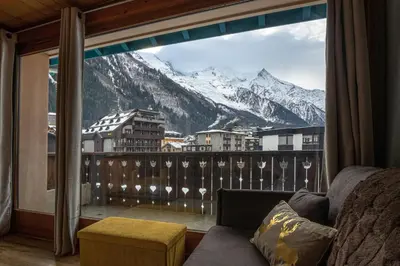 a room with a balcony with a view of a mountain at Refuge de l'Aiguille - 2 bedroom duplex in the heart of Chamonix in Chamonix-Mont-Blanc